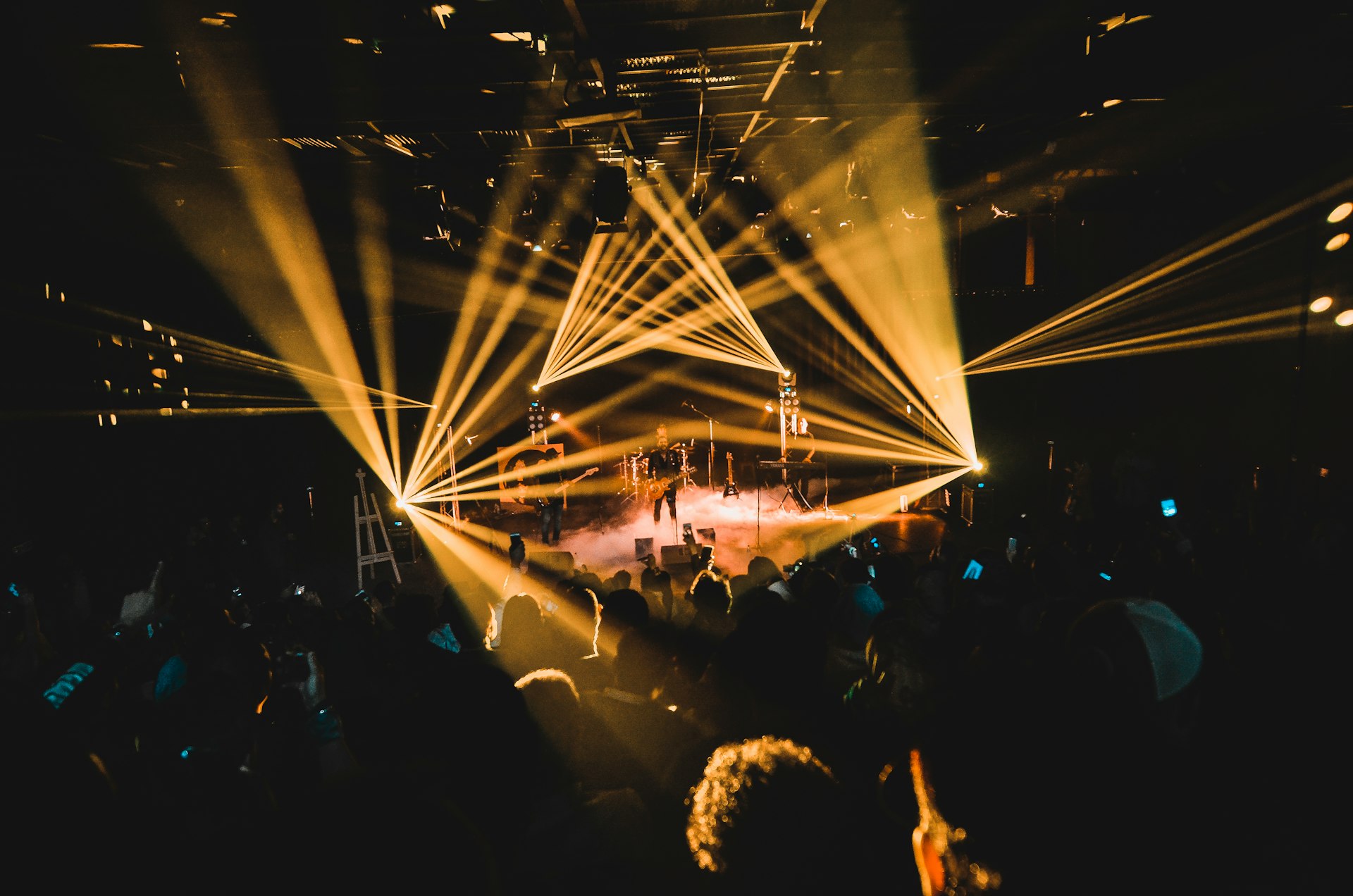 people standing on stage with lights